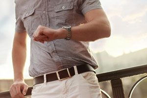 man looking at watch waiting for his class action lawsuit settlement check