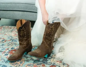 Bride putting on her best cowgirl boots for the wedding in Texas