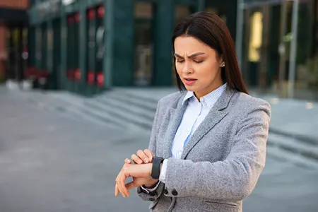 Class Action Settlements Take Time Female Lawyer Checking Watch